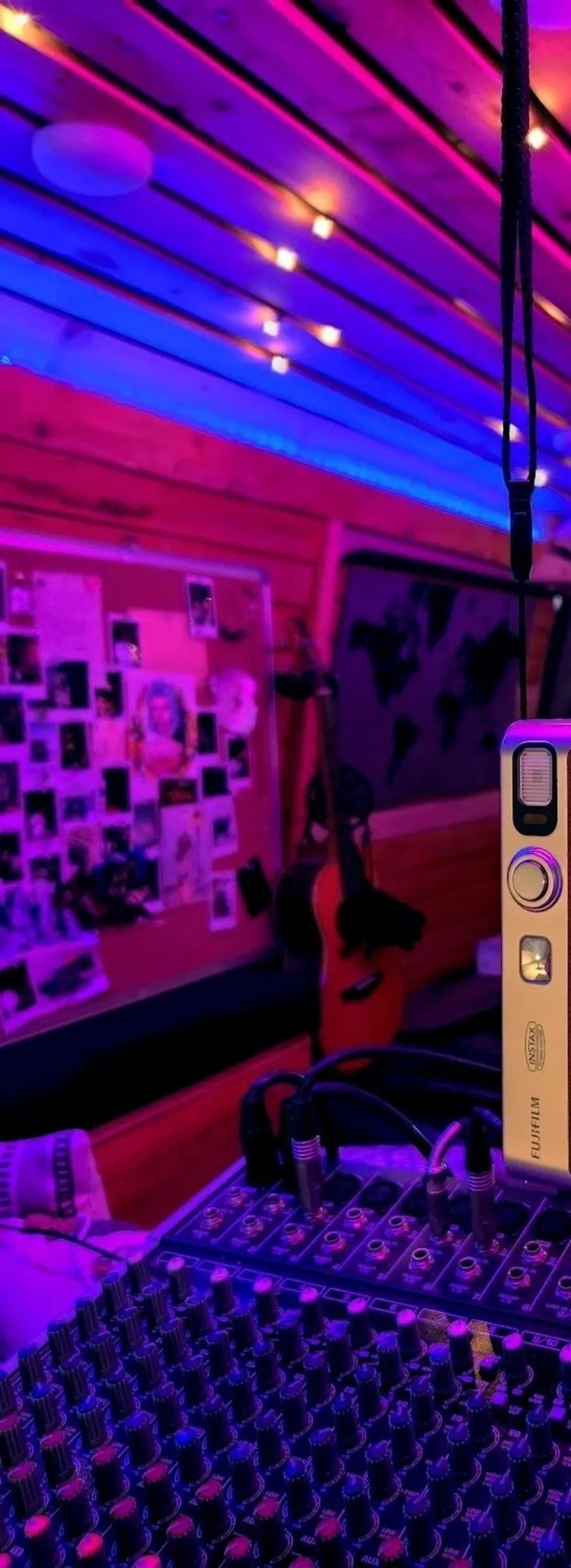 Instant camera and mixing desk inside the neon-lit van