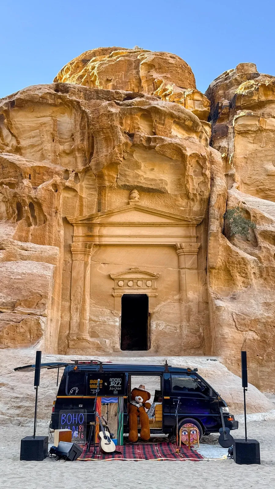The van parked at a carved rock facade in Little Petra