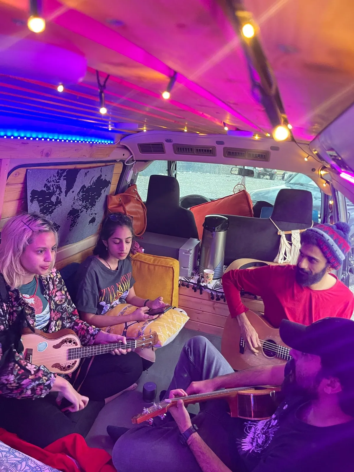 Four musicians who had just met, playing together inside the van